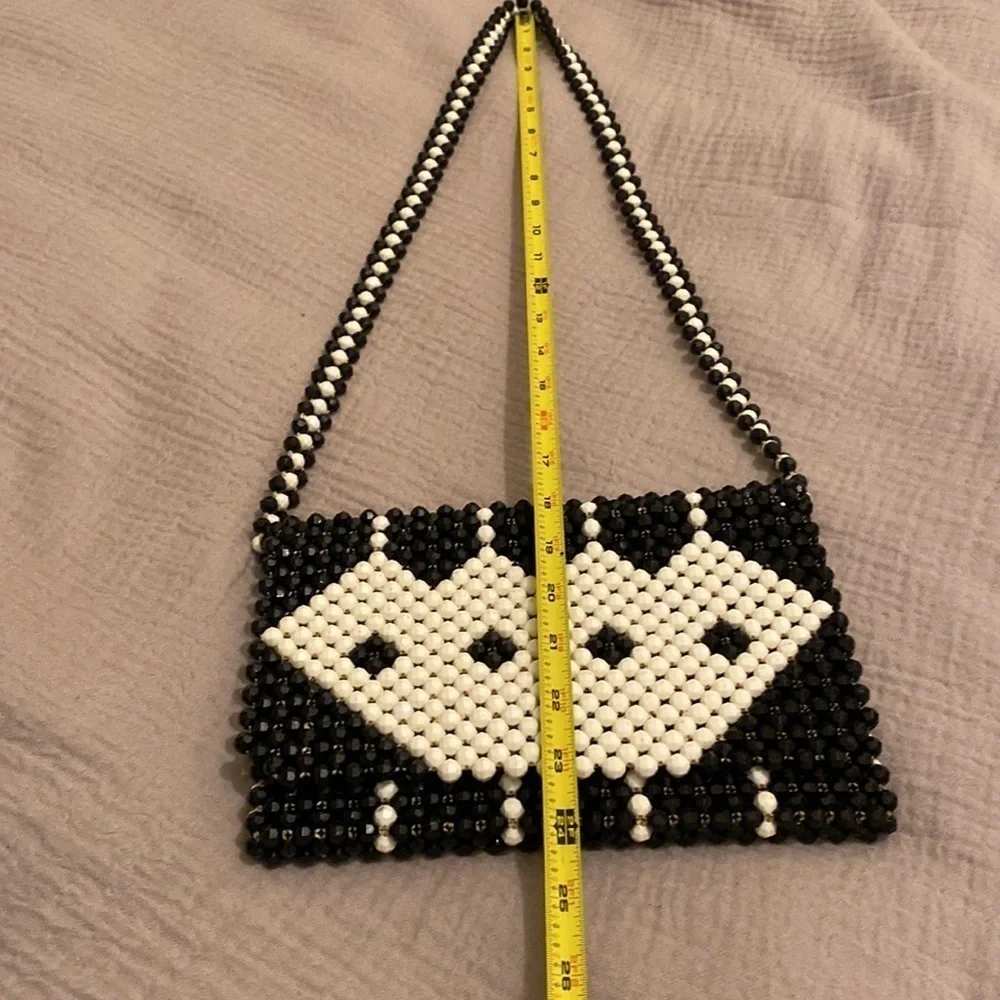 Black and white beaded shoulder beautiful bag .